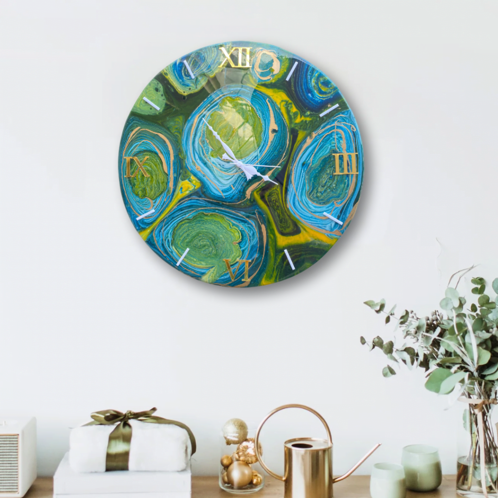 Galactic Swirl - Unique Round Resin Clock | Fankaarlok features a vividly colored wall clock designed with swirling blue, green, and gold patterns that mimic a dynamic galaxy. The intricate resin design is complemented by Roman numeral indicators, enhancing its artistic and contemporary feel. Perfect for modern home decor.