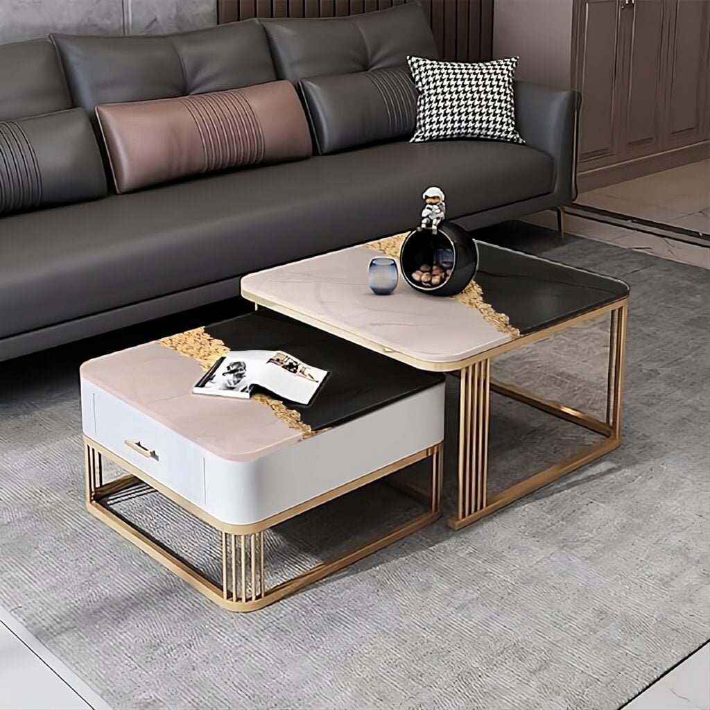 Contemporary nested Modern coffee table set featuring a modern design with two overlapping tables. The larger table has a sleek black surface framed in gold, while the smaller table combines a cushioned beige seat with a marble-like tabletop. These versatile pieces are perfect for a stylish living room, providing both functionality and chic aesthetic with their distinctive construction and contrasting textures.