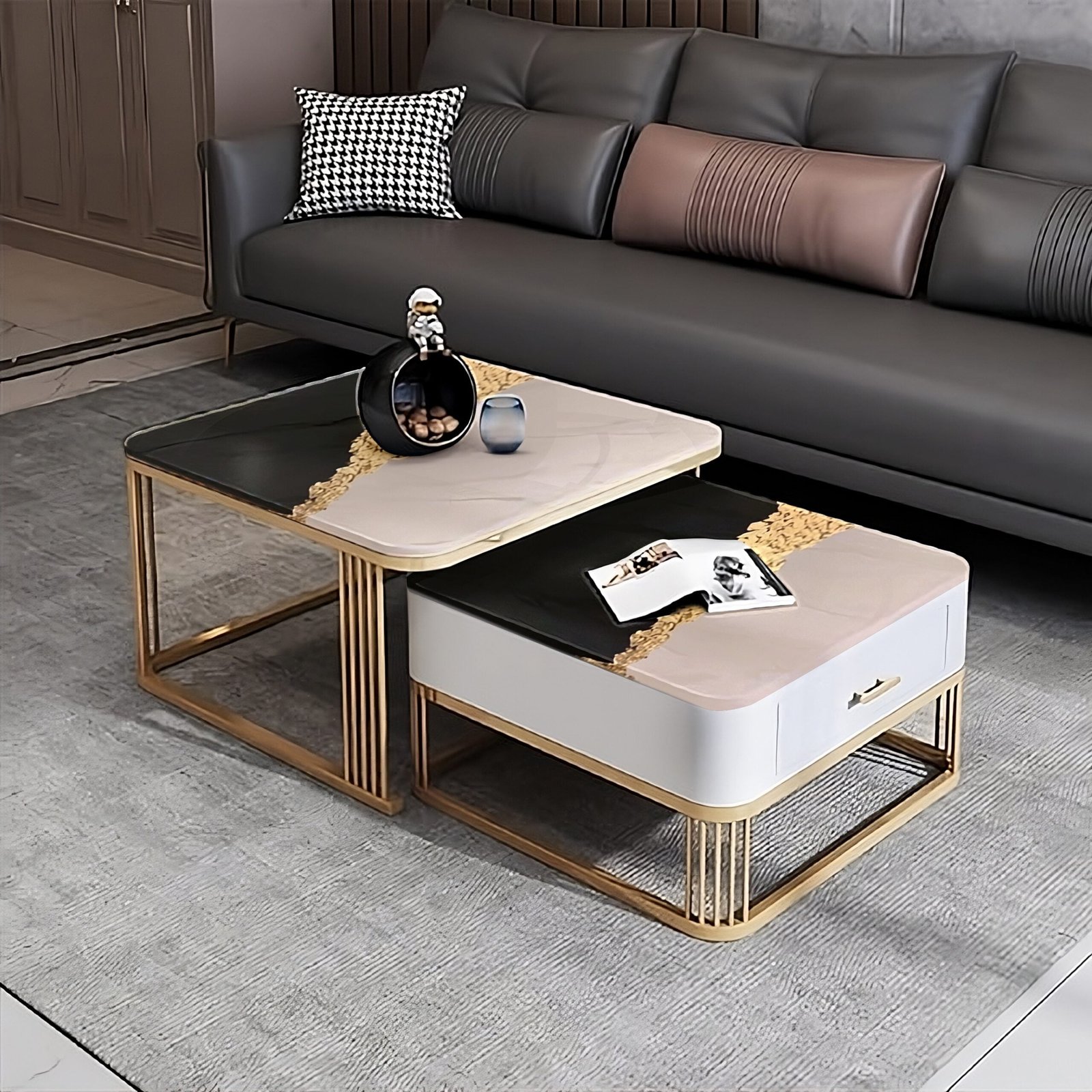 Modern nested coffee tables in a contemporary living room setting, featuring a unique dual-tone design. One table is sleek black with a gold rim, and the other is white with a gold base, both crafted with clean lines and a minimalist aesthetic. The tables are styled with a wine bottle, a glass, and reading materials, complementing the chic gray sofa in the background.