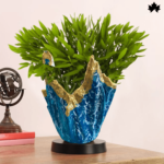 Unique designer planter from Fankaarlok featuring a vibrant blue resin body with striking gold accents. The jagged, abstract shape and rich colors make it an eye-catching piece of home decor, ideal for adding a splash of color and elegance to any indoor space.