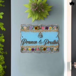 Customized Floral Bliss Customized Door Nameplate by Fankaarlok, featuring a light blue background with the names 'Praveen & Preethi' in elegant script, bordered by intricate gold detailing and a vibrant assortment of multicolored flowers.