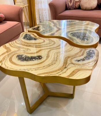 The Dual-Tone Artistic Custom Tables Table from Fankaarlok features a uniquely organic design with smooth, flowing lines and dual-tone wood, accented by embedded geode-like resin inclusions. Its luxurious gold frame complements the natural hues of the tabletop, making it a striking centerpiece for any modern living space.