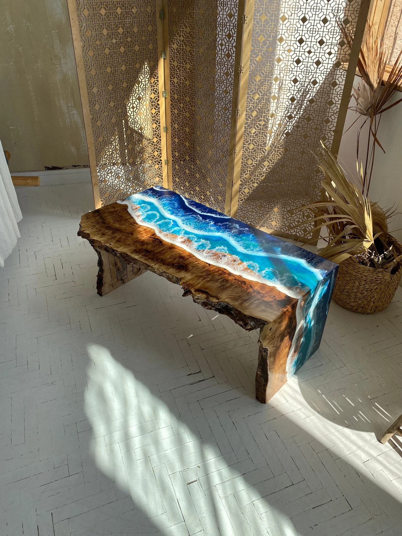 luxury center tables. A luxury center tables featuring a natural wood base and a stunning resin art top that mimics an oceanic view, perfectly blending rustic charm with modern artistry, ideal for sophisticated interior decor.