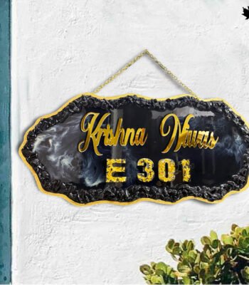 Step into sophistication with the "Elegant Hanging" Designer Resin Nameplate from Fankaarlok. This striking piece features a bold, black resin background contrasted with golden lettering and a unique marbled effect, offering an opulent touch to your doorway. Whether it's for your home or as a thoughtful gift, this nameplate ensures a grand entrance every time, reflecting both style and personal identity. Perfect for modern homes looking for a blend of class and durability.