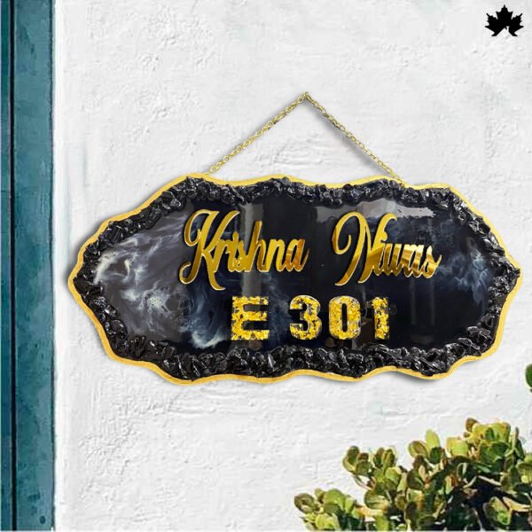 Step into sophistication with the "Elegant Hanging" Designer Resin Nameplate from Fankaarlok. This striking piece features a bold, black resin background contrasted with golden lettering and a unique marbled effect, offering an opulent touch to your doorway. Whether it's for your home or as a thoughtful gift, this nameplate ensures a grand entrance every time, reflecting both style and personal identity. Perfect for modern homes looking for a blend of class and durability.