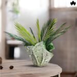 Artisan Folded Leaf -Large Decorative Planters | Fankaarlok large decorative planter by Fankaarlok, designed to mimic the organic allure of folded greenery. This sculptural planter features a textured surface that resembles a stone-carved leaf, brought to life in concrete and resin for durability and detail. Perfect for housing vibrant ferns or cascading foliage, this piece combines functionality with artistic expression, making it an ideal choice for enhancing any indoor or outdoor space with a touch of nature-inspired artistry.