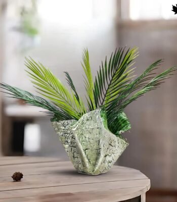 Artisan Folded Leaf -Large Decorative Planters | Fankaarlok large decorative planter by Fankaarlok, designed to mimic the organic allure of folded greenery. This sculptural planter features a textured surface that resembles a stone-carved leaf, brought to life in concrete and resin for durability and detail. Perfect for housing vibrant ferns or cascading foliage, this piece combines functionality with artistic expression, making it an ideal choice for enhancing any indoor or outdoor space with a touch of nature-inspired artistry.