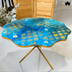 The Ocean Bliss - Artistic Deco Resin Masterpiece Coffee Table by Fankaarlok is a vibrant, handcrafted resin masterpiece that brings the beauty of the ocean right into your living space. Its striking blue hues and intricate grid patterns evoke serene ocean waves and sunny skies, accented with whimsical white flowers for a touch of elegance. Perfect for adding a splash of color and artistry to any modern decor.